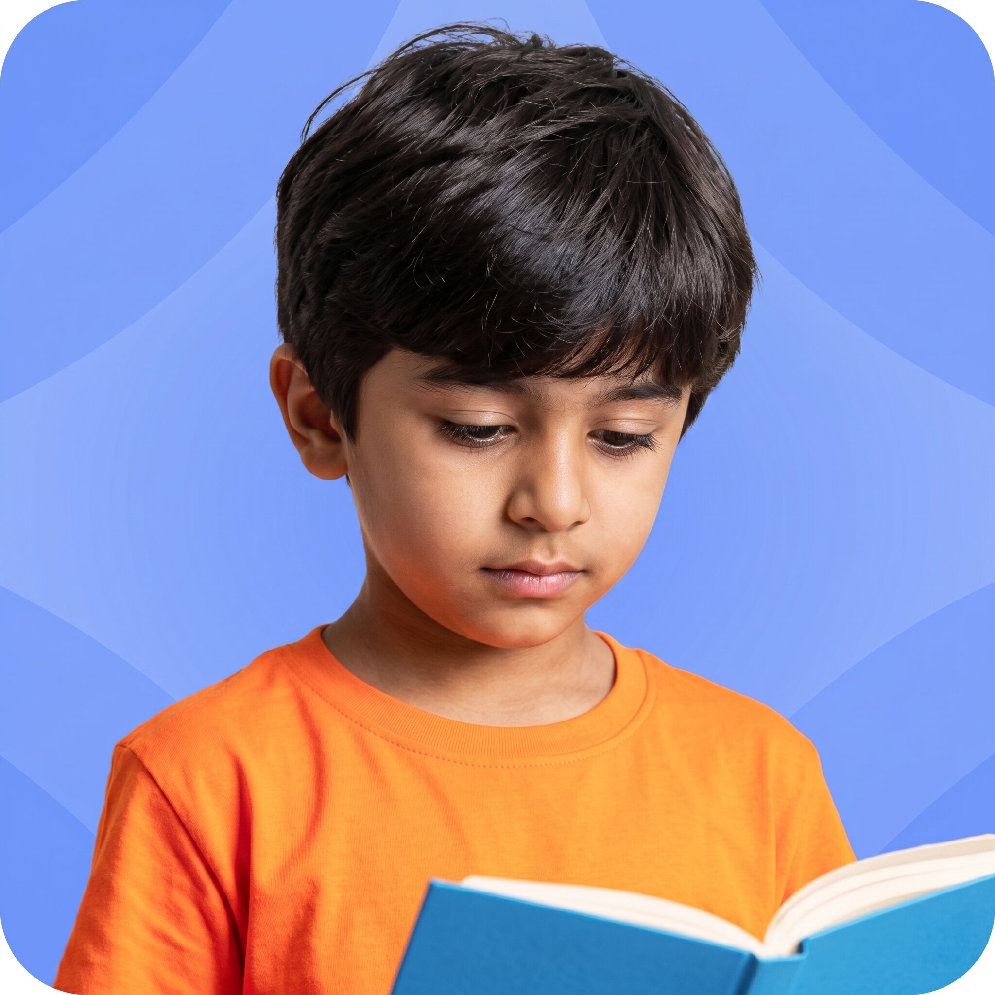 A young boy in an orange t-shirt reading a book